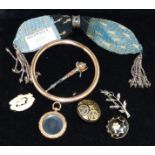 A rolled gold bangle stamped 'CH'; mourning brooches; a carved bone brooch; a stocking purse; a