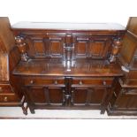 A Jacobean style oak buffet sideboard with double cupboard over 2 cupboards and 2 drawers