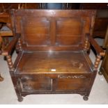 A 1930's oak box seat monks bench