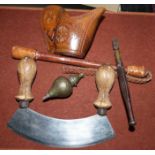 A Victorian brass/steel plumb bomb; a woven leather cosh; a vegetable chopper; an antique glass