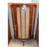 A 1930's walnut bow front china cabinet