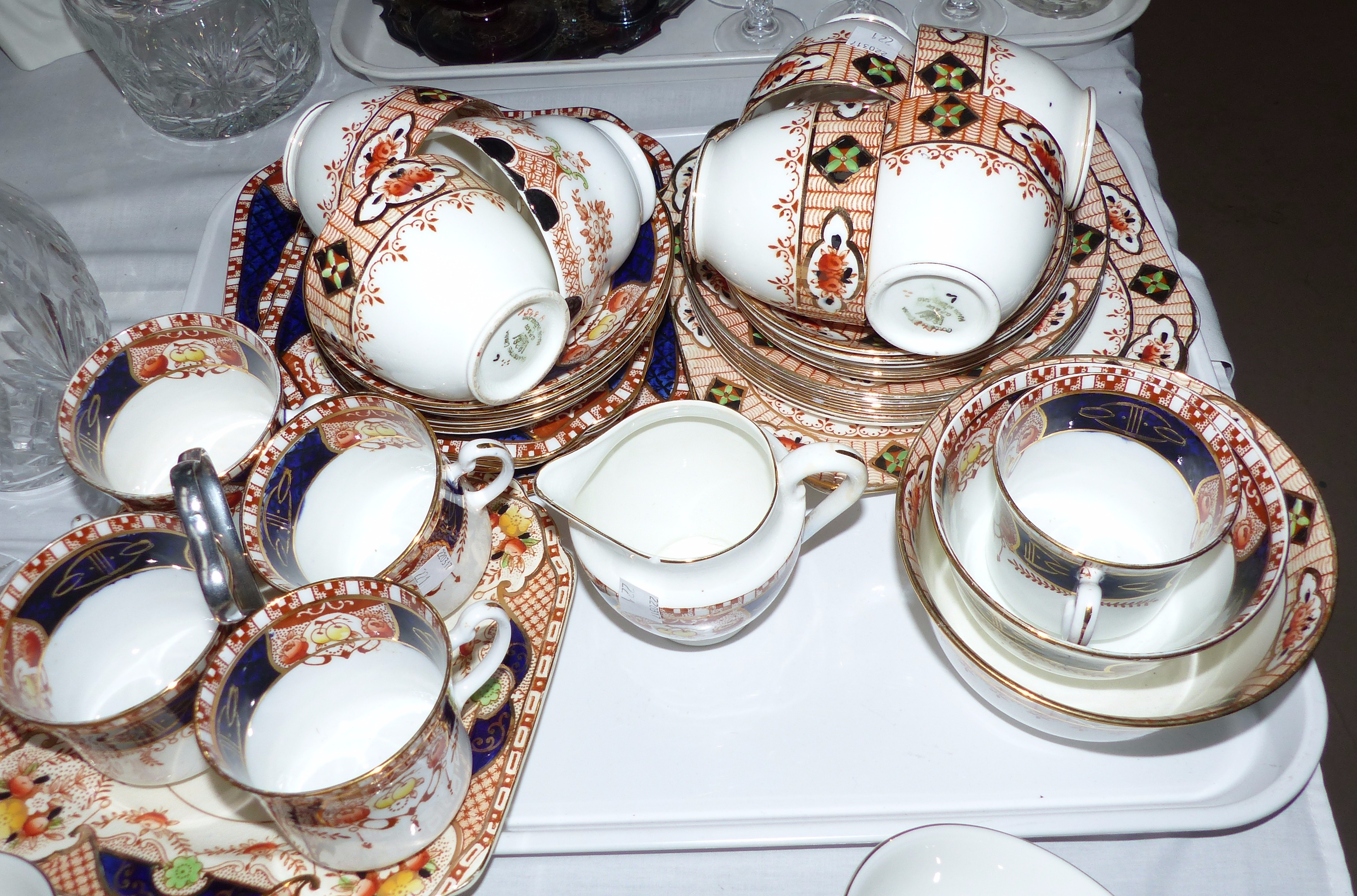 Two 1920's bone china tea services with gilt transfer decoration