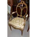 A 19th century Adam style gilt wood armchair, the oval back with fleur-de-lys motif, overstuffed