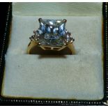 A dress ring stamped '14K' set with a large rectangular diamond simulant