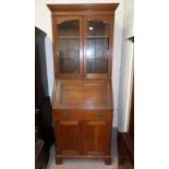 An early 20th century Arts & Crafts bureau bookcase, with 2 glazed doors, fall front and double