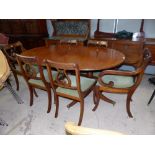 A reproduction Regency style yew and mahogany dining suite comprising extending oval twin pedestal