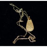 A Middle Eastern bow and arrow pendant, stamped '750', on chain stamped '9KT', pendant 3.6 gm, chain