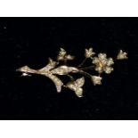 A 9 carat hallmarked gold floral spray brooch set with a diamond and seed pearls, 4.3 gm