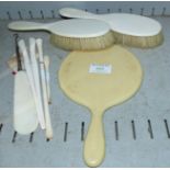 A pair of Edwardian ivory back hairbrushes; a simulated ivory back mirror; glove stretchers; two