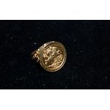 A 9 carat hallmarked gold ring set with small St George medal, gross weight 3 gm