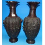 A pair of late 19th century Japanese bronze baluster vases with high relief birds in brambles