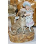 A large Victorian bisque group of a child feeding a dog, 14½"