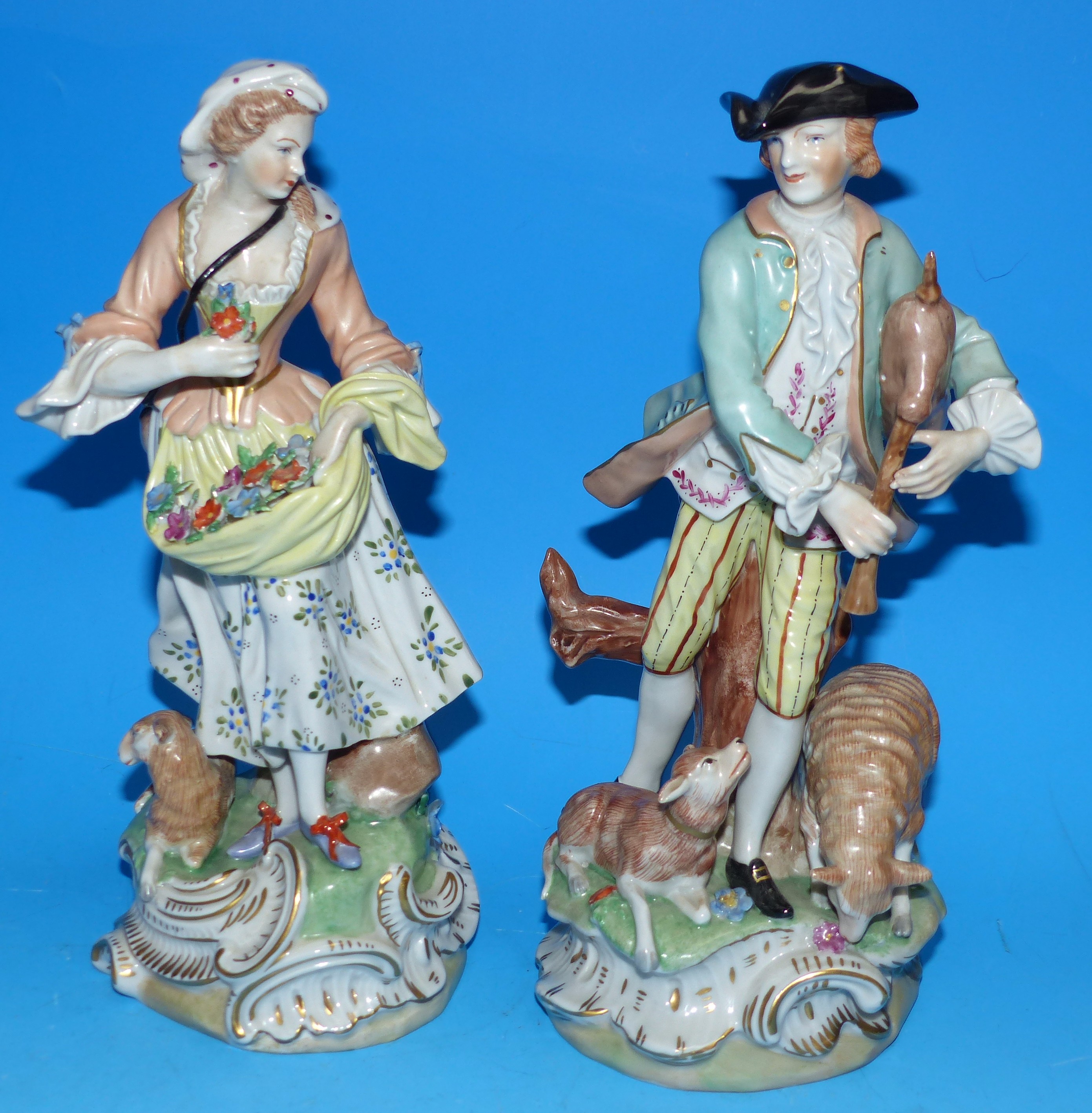 A pair of 20th century Dresden figures: man and woman with animals, 10"
