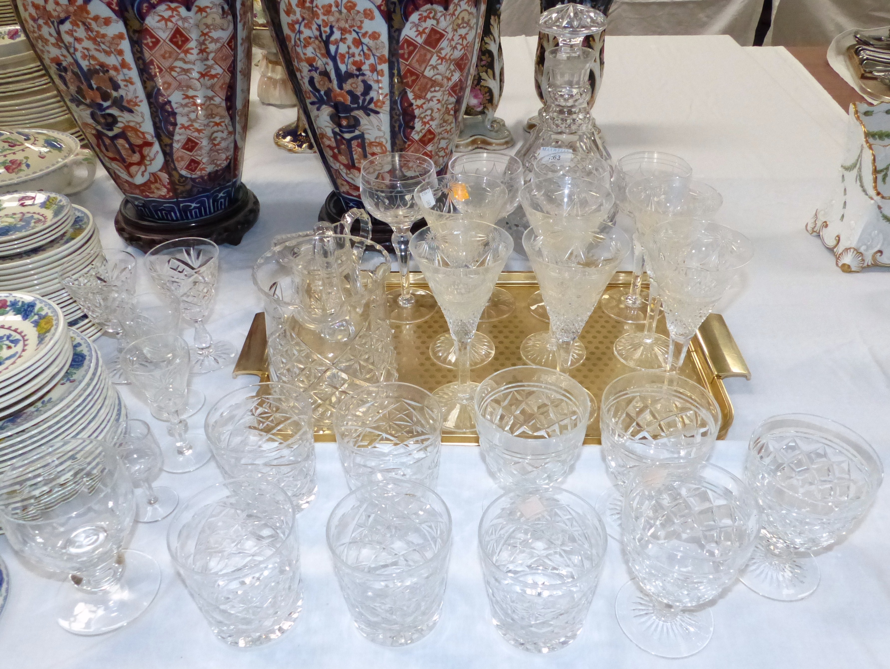 A large cut glass mallet shaped decanter; a selection of cut drinking glasses