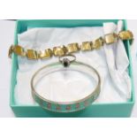 A Tiffany and Co silver bangle with floral beaded turquoise enamel decoration; a 9ct gem set dress