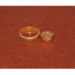 A 9 carat hallmarked gold wedding ring; a child's signet ring, stamped '9C', 6.2 gm