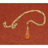 An amber coloured tear drop pendant on 9 carat hallmarked gold chain (weight of chain 5.3gm approx)