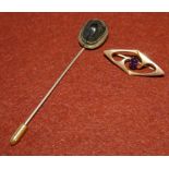 An Edwardian amethyst set bar brooch stamped 375 (1.3gms); a scarab beetle stick pin