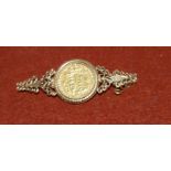A QV 1887 half sovereign in later 9 carat gold brooch mount, 11.7 gm