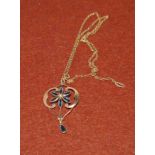 An Art Nouveau sapphire and seed pearl pendant stamped 18ct on chain stamped 9ct (gross 3.4gms)