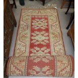 A modern Persian design runner, hand knotted with rust ground