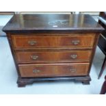 A period style oak and mahogany 3 height chest of drawers with inlaid decoration and ogee bracket