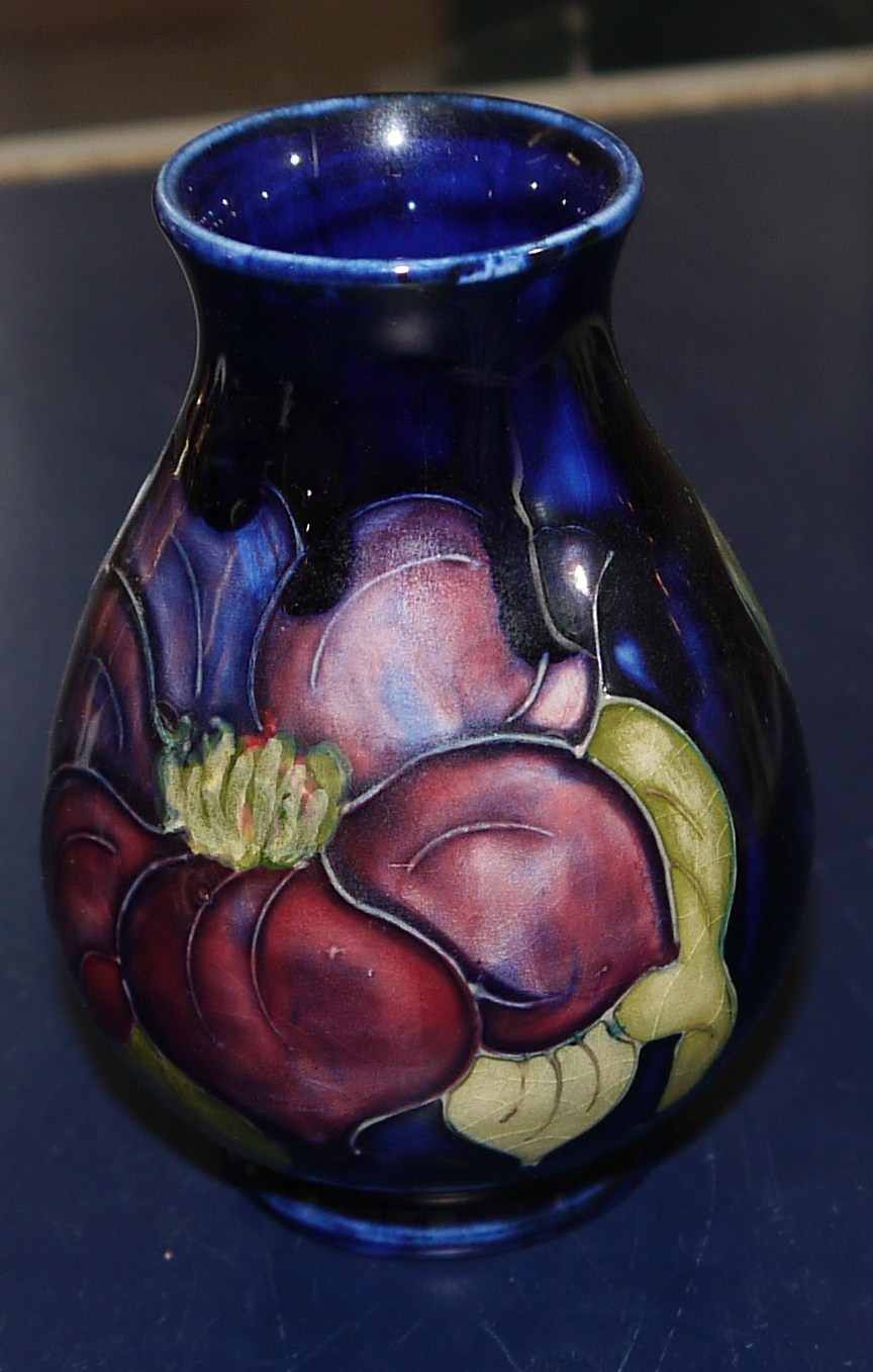 A small baluster Moorcroft vase anemone against a blue ground, ht 4"