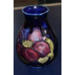 A small baluster Moorcroft vase anemone against a blue ground, ht 4"