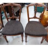 A late 19th/early 20th century set of 6 walnut dining chairs on turned tapering legs, the backs with