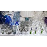 A set of four green and five blue wine glasses with coloured air twist stems and a selection of