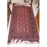 A modern small Bokhara rug, hand knotted with rust ground