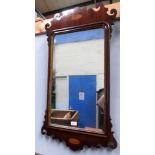 A 19th century Georgian style mahogany framed mirror with shell inlaid decoration and fretwork frame