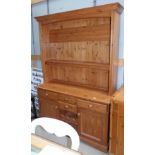 A modern pine Welsh dresser with 2 height Delft rack over