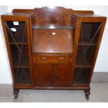 A 1920's / 30's oak side by side display cabinet with central bureau, double cupboard and single