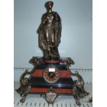 A 19th century bronze and marble mantel clock surmounted by a classical female, with French drum
