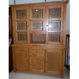 A modern light oak display sideboard with 3 bevelled glass doors above and single drawer and 3