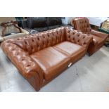 A traditional style 2 piece lounge suite in tan leather effect, comprising Chesterfield settee and