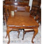 A 1930's burr walnut dining suite comprising table with one extra leaf, 4 chairs with matching