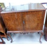 A burr walnut reproduction cocktail cabinet with double doors, on cabriole legs