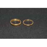 Two 22 carat hallmarked gold wedding rings, one inscribed internally, 7 gm