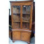A mahogany concave bow front corner cupboard in the Reprodux style, height 75"