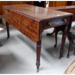 An early 19th century mahogany Pembroke/dining table with frieze drawer, on turned reeded legs and