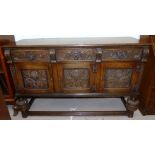 An oak reproduction sideboard on bulbous legs with 3 carved doors and 3 drawers, length 59"