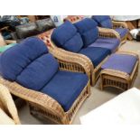 A cane conservatory suite comprising 2 seater settee, 3 armchairs and a stool