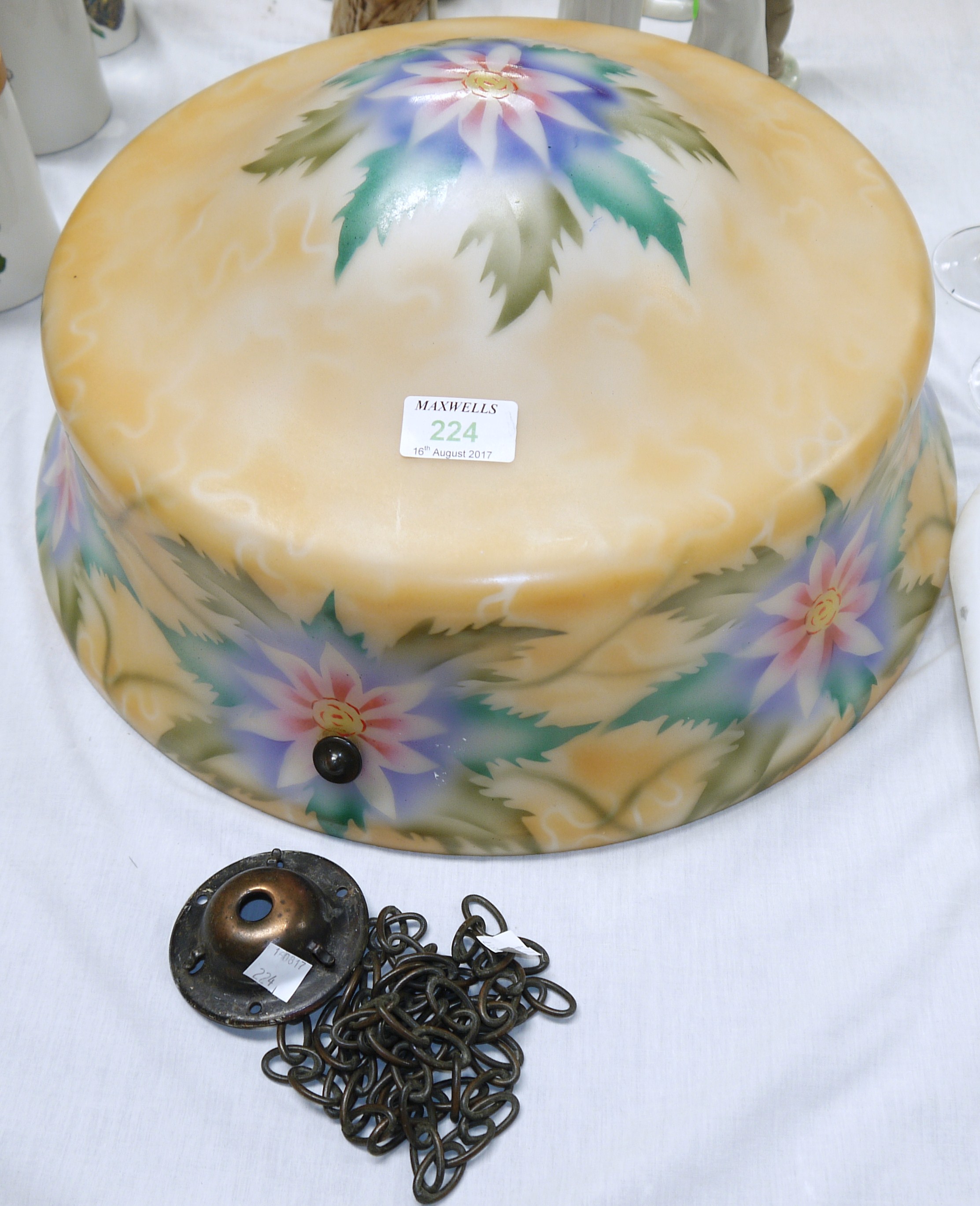 A 1930's opaque glass ceiling light globe decorated with flowers