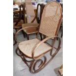 A bentwood rocking armchair with cane seat and back