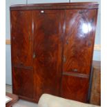 An Edwardian mahogany triple fitted wardrobe