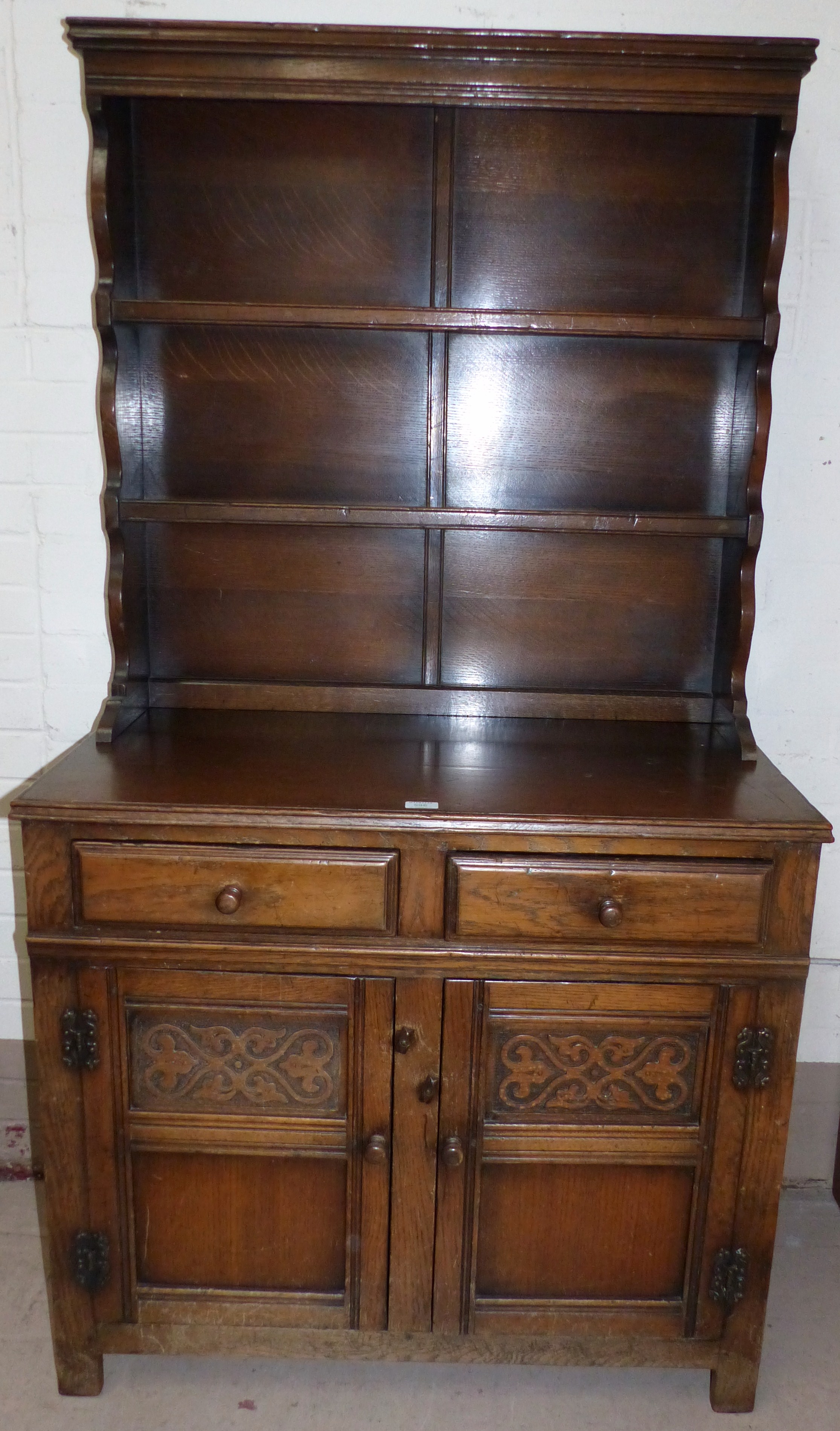 A Jacobean style oak dresser with rack over double cupboard and double drawers, width 37"