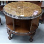 A burr walnut reproduction circular coffee/occasional table with storage under, on ball and claw