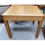 A modern light oak extending dining table with 2 chairs